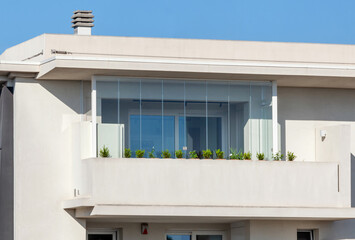 Veranda balcony with transparent glass without frames for a concealed result.