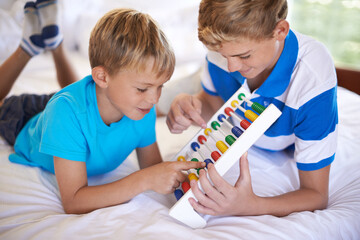 Children, home and playing with abacus for learning, happy and bonding together with educational for math. Brother, teaching and counting game on bed with sibling love, care and development in house