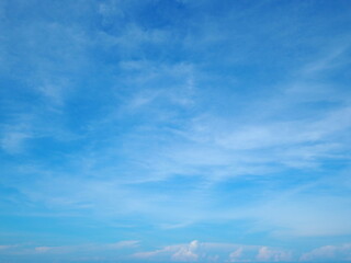 The bright blue sky and fluffy white clouds are the beauty of nature. The atmosphere of the sky in...