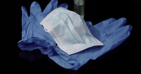 Protective Mask Isolated on Black Background Rotating. Medical Mask Protective Gloves.