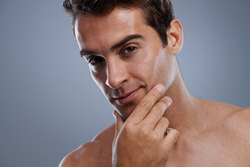 Portrait, shaving and man with skincare, cosmetics and dermatology on grey studio background. Face,...