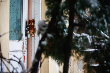 Winter in the yard of the house seen through the window. Lifestyle.