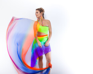 Woman with colorful clothes, isolated on a horizontal background, dancing with colorful fabric
