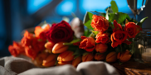 Romantic flower still life with red roses and tulips. Background with short depth of field. Concept for wedding and valentine's day.