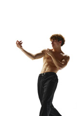 Portrait of half-naked handsome young man moves his hands smoothly against white studio background....