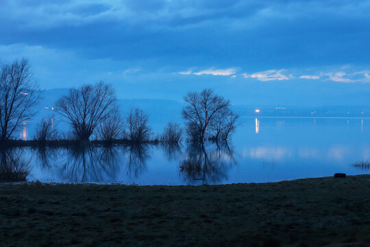 Evening mist by the lake in winter.