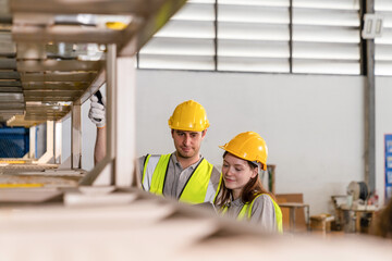 Warehouse worker and managers check stock and inventory by using digital tablet computer in the...