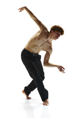 Obraz premium Contemporary dance performances. Male dancer in black pants, bending toward in dance pose against white studio background. Concept of human motions, wellness, natural beauty of male body.