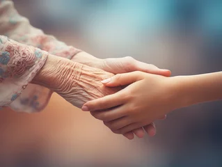 Photo sur Aluminium Vielles portes Young woman giving hands to elderly grandmother, close up. Young woman giving comfort and support to senior woman at moment of stress, grief, despair, disease. Family, empathy concept.
