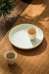 Fototapeta na wymiar Image of tea set, person making Asian-style tea, tea cup and teapot