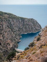 view of the blue water of a bay in the mediterranean sea on the coast of turkey. rocky coast with green plants