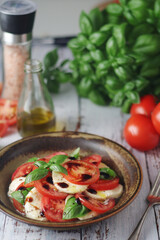 A bowl with traditional Italian caprese salad	
