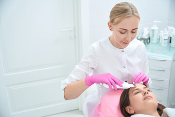 Professional procedure, skincare, female working with customer