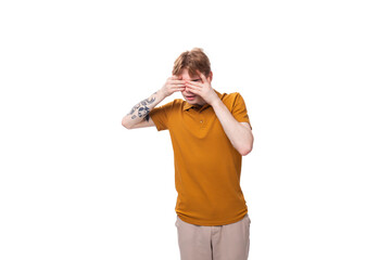 young fashion student man with short red hair dressed in yellow t-shirt