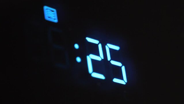 A close-up view of a digital electric oven screen timer as it counts down from thirty seconds to zero, the glowing numbers decrease as time progresses.