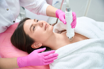Obraz na płótnie Canvas Cosmetology procedure, female working with customer in clinic