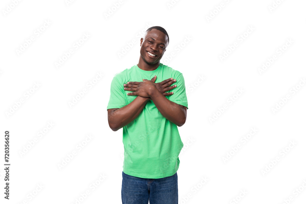 Wall mural young friendly american man dressed in green t-shirt and jeans