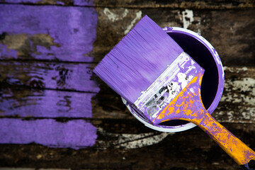 Brush the variegated color paint onto the weathered wooden plank wall