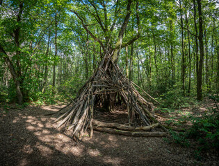 Dardilly, France - 09 03 2022: View of a wooden teepee in the forest Bois de Serre, Edge of the woods.
