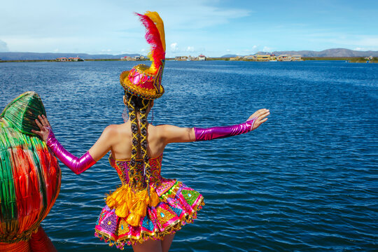 Beautiful dancer dressed in the typical costume of the Candelaria festival, invites you to visit the island of Uros and Lake Titicaca in Puno, Peru