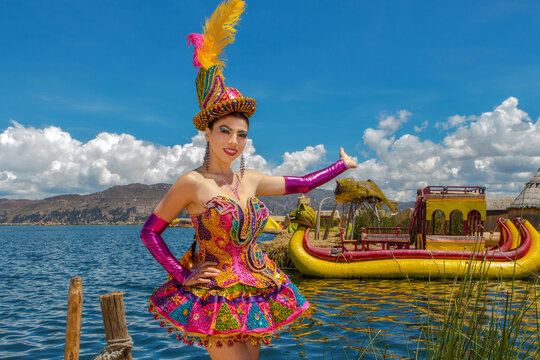 Beautiful dancer dressed in the typical costume of the Candelaria festival, invites you to visit the island of Uros and Lake Titicaca in Puno, Peru