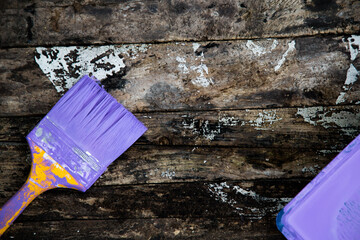 Brush the variegated color paint onto the weathered wooden plank wall