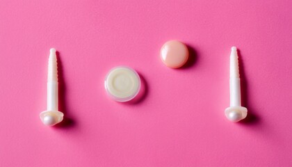 A pink background with 5 different colored plastic items