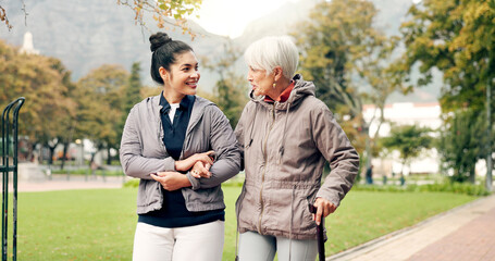 Senior woman, walker and nurse talking in a park with healthcare for elderly exercise. Walking,...
