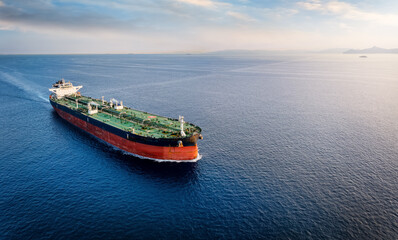 Aerial view of a large crude oil tanker traveling over open ocean with copy space