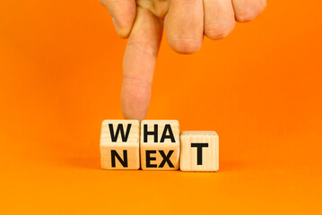 What next symbol. Concept words What next on wooden blocks. Changed words what to next. Beautiful orange table orange background. Businessman hand. Business What next concept. Copy space.