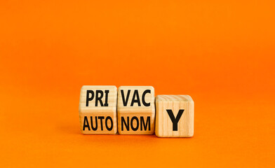 Privacy or autonomy symbol. Concept word Privacy or Autonomy on wooden cubes. Beautiful orange...