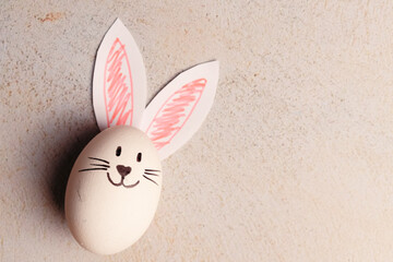 Photograph of an egg with bunny ears. Easter concept.