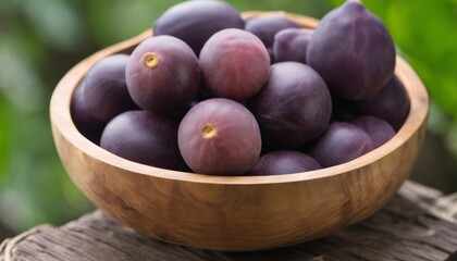 Fototapeta premium A wooden bowl filled with purple grapes