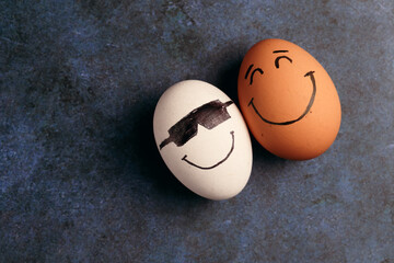 Photograph of a white egg together with a brown egg.