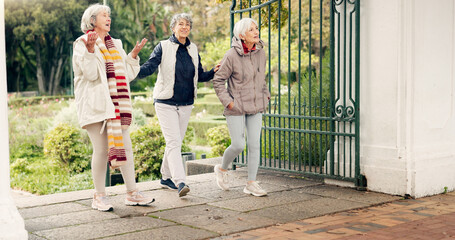 Senior friends, walking and talking together on an outdoor path to relax in nature with elderly...