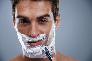 Man, razor and shaving in studio closeup for grooming, skincare and beard in portrait by grey...