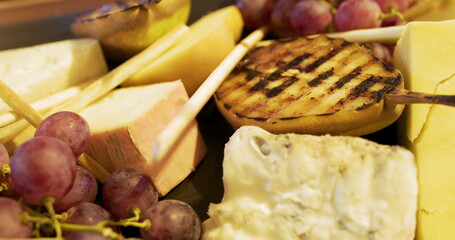 different types of cheese on wooden board in the restaurant