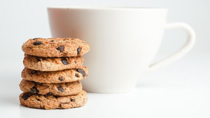 Fototapeta na wymiar Chocolate chip cookies and a glass of milk coffee on a white background