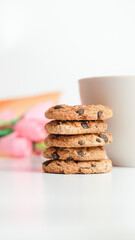 Chocolate chip cookies and a glass of milk coffee on a white background