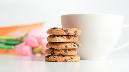 Chocolate chip cookies and a glass of milk coffee on a white background