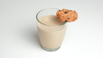 Chocolate chip cookies and a glass of milk coffee on a white background
