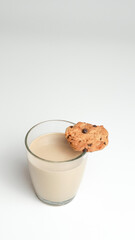 Chocolate chip cookies and a glass of milk coffee on a white background