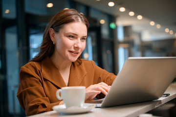 Happy lady attentively typing something on computer