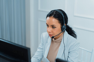 African American young businesswoman wearing headset working in office to support remote crucial...