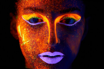 Portrait, art and beauty with neon woman on black background for makeup, glitter or colorful glow. Face, fantasy and creative with confident young person in the dark for psychedelic or techno paint