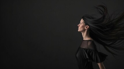 Stunning model with long black hair on black background, space for hair care and beauty product ad