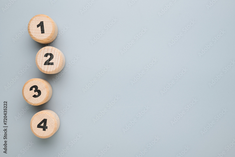 Aufkleber 1, 2, 3, and 4 arranged by round wood blocks with empty space, procedure, method, step by step list