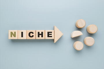 Find a niche concept by alphabet wood blocks, with direct arrow symbol, and different wood toy