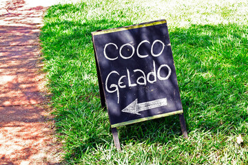 Small poster with inscription in Portuguese that says: Iced coconut