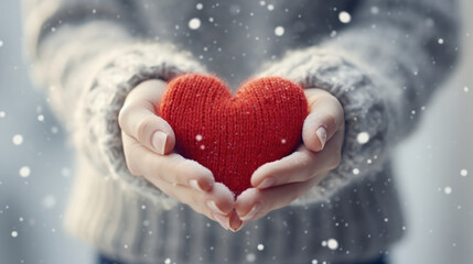 Women's Day, Female Hands Holding Red Yarn Knitted Hearts of Love on a Snowfall Winter Day